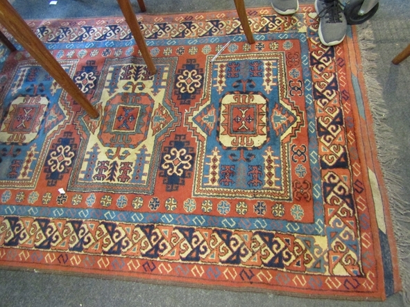 A terracotta ground geometric patterned rug