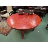 A Victorian mahogany circular dining table on melon-fluted legs to castors, no winding handle.