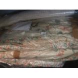 A pair of cream ground floral curtains each approximately 200cm wide with 216cm drop,