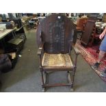 An early 20th Century monks chair with carved floral detail