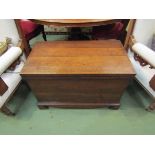 A George III oak chest the hinged lid and brass carrying handles over bracket feet with lidded