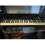 A Yamaha PSR-210 organ keyboard with stand