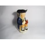A late 18th early 19th Century Toby jug with figural handle.