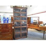 A 1920's oak six-tier bookcase, each section with a pair of lead glazed doors,