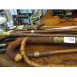 A quantity of assorted walking sticks including silver collar example