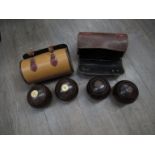 Two sets of vintage lignum vitae lawn bowls,