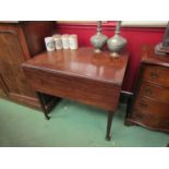 A George III mahogany Pembroke table on chamfered tapering legs and carved feet,