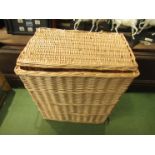 A wicker lidded laundry basket