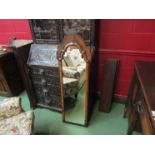 An 18th Century style walnut pier mirror with cushioned frame,