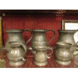 Three pewter quart tankards and three smaller examples