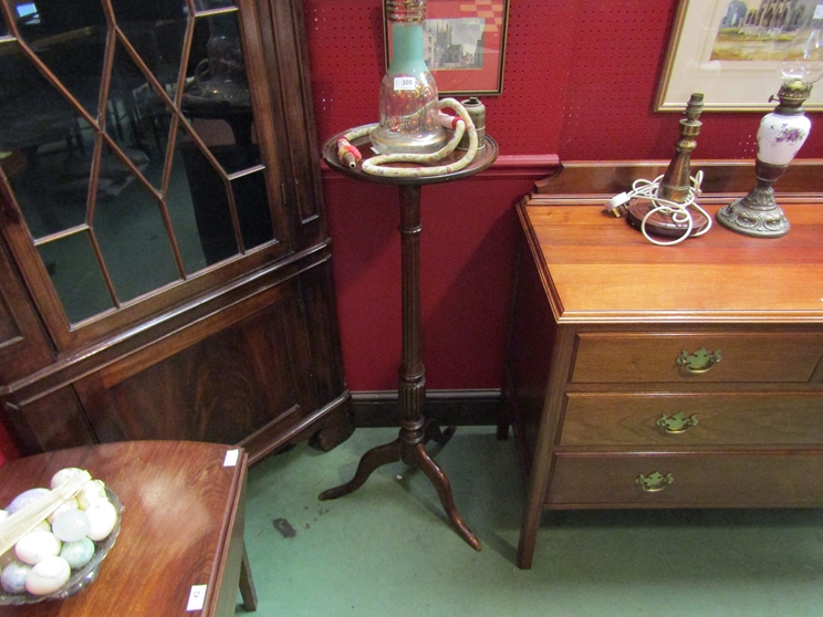 A mahogany jardiniere stand on fluted column and tripod feet,