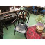 A 19th Century elm and oak wheel-back elbow chair the dished seat over turned legs joined by an 'H'