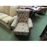 A pair of Edwardian Howard/Shoolbred style country house armchairs with sprung front edge on ring