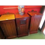 A late Victorian walnut bedside cupboard the carved raised back over a single door on a plinth base,