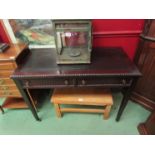 An Edwardian mahogany writing table with beaded edge decoration over two frieze drawers on square