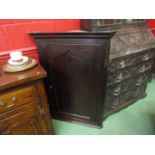 A circa 1830 oak corner cupboard with panelled single door and key,