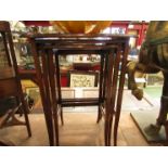 An Edwardian mahogany oval top nest of three graduating occasional tables,