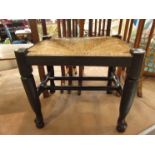 A 19th Century rush seat stool on pad foot cabriole legs joined by turned stretchers,