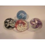 Four Caithness art glass paperweights with boxes