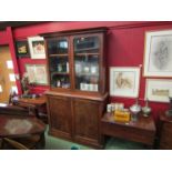 A Victorian mahogany glazed bookcase over cupboard base,