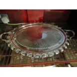 A silver plated oval tray with embossed detail,