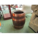 A coopered oak barrel with swing handle,