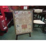 A print of a needlepoint on easel stand