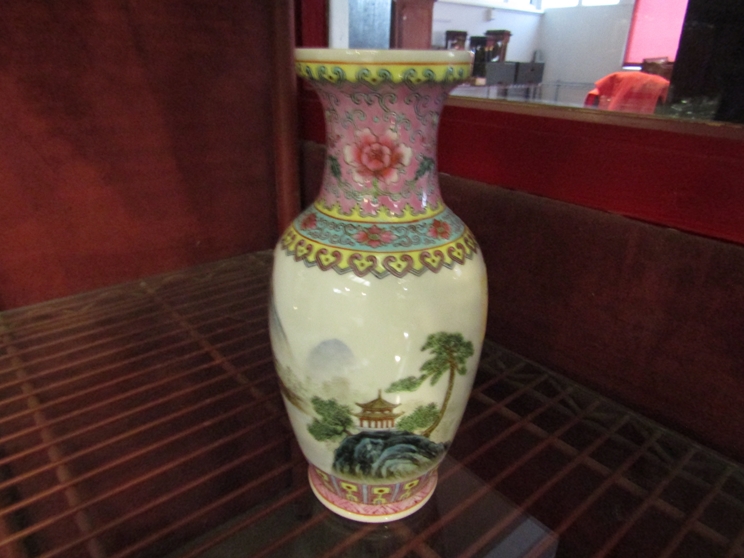 A 20th Century Chinese porcelain vase decorated with mountain temple design,