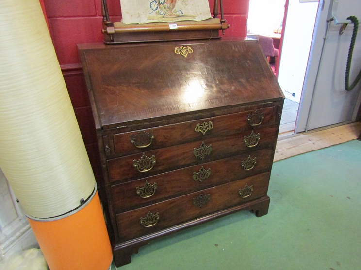 A George III flame mahogany bureau the fully fitted interior over four long drawers and bracket