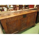 An 18th Century oak coffer with carved panel front, candle box to interior,