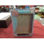 A Tiffany style lead glazed picture frame with stylised rose,