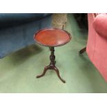 An Edwardian mahogany Georgian style wine table the circular dished top with beaded edge over a