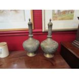 A pair of Far Eastern brass lidded bottle vases, all over detail,