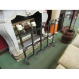A wrought iron three tier candle stand with candles,