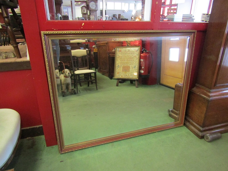 A gilt framed overmantel mirror with bevelled edge,