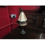 A bronzed Art Deco style lamp base with Tiffany style leaded shade,