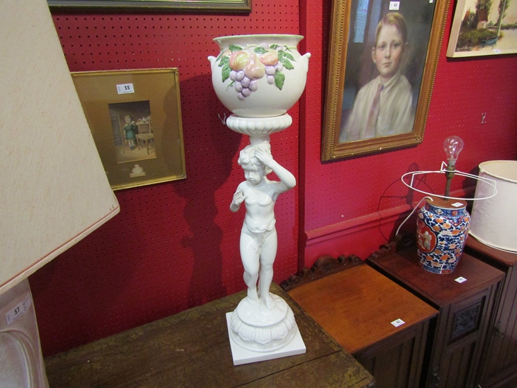 A modern Continental white glazed ceramic jardiniere on figural stand,