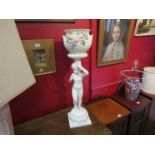 A modern Continental white glazed ceramic jardiniere on figural stand,