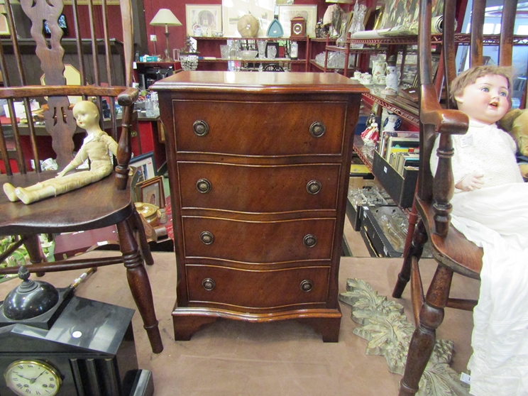 A Georgian style flame mahogany serpentine front chest of small proportions,