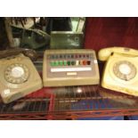 A cream dial telephone and another a/f with a switchboard