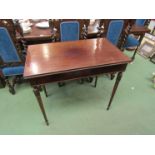 A mahogany side table with concealed frieze drawer and carved tapering turned legs