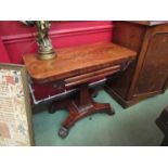 A George IV mahogany card table with fold-over swivel top and baize interior on quatreform base,