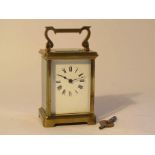 An early 20th Century brass cased French carriage timepiece with enamelled Roman dial,
