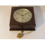 An early 20th Century American Poole electric wall clock in wlanut veneered case with hinged door