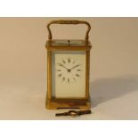 A late 19th Century/early 20th Century brass cased carriage clock, Roman enamelled dial,