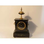 A late 19th Century slate mantel clock with gilt spelter surmounting urn and and winged side mounts,