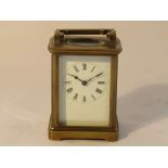 A late 19th Century brass cased carriage timepiece with enamelled Roman dial,