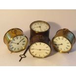 Four early 20th Century French drum form brass cased timepieces with Roman dials,