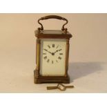 A late 19th Century brass cased French carriage timepiece with enamelled Roman dial,