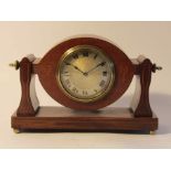 An Edwardian mahogany and strung inlaid timepiece, silvered Roman dial with embossed centre,